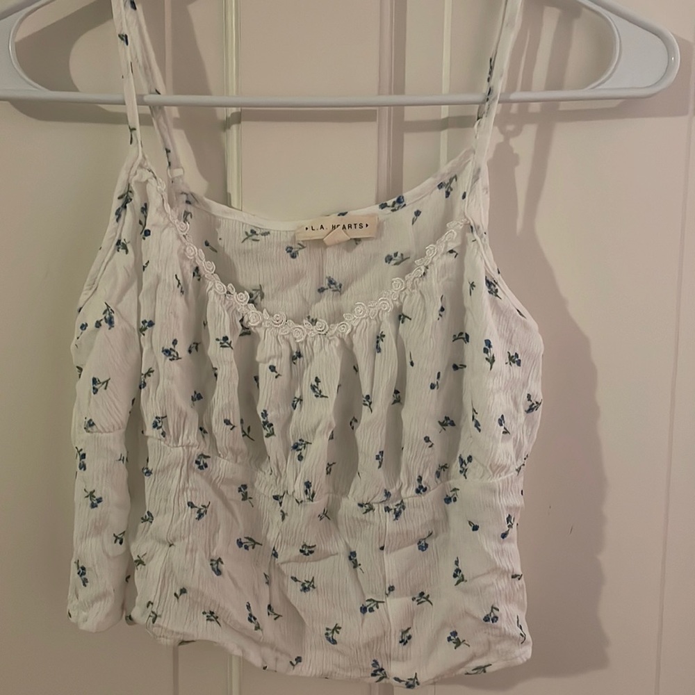 White tank with blue flowers & white floral trim. Adjustable straps.